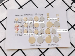 Assorted gold and silver round metal jewelry pendants in various sizes for DIY crafting