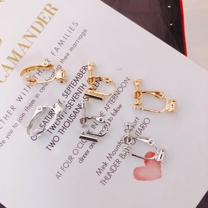 Detail of adjustable gold and silver screw earring converters for non-pierced ears