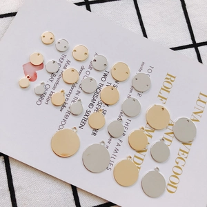 Detailed view of round gold and silver metal pendants for DIY jewelry making accessories