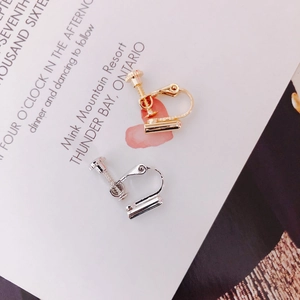 Close-up of gold and silver adjustable screw earring converters for non-pierced ears
