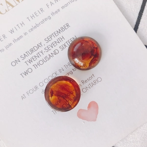 Close-up of translucent amber acrylic round buttons for DIY earring jewelry making