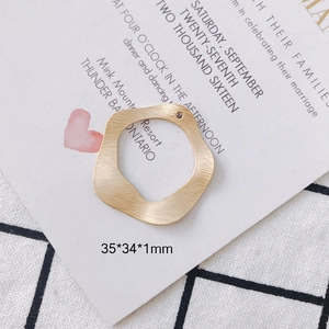 Detailed macro view of 35x34mm matte gold wavy hollow round metal pendant for DIY jewelry