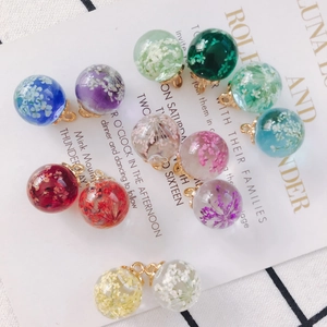 Handmade clear glass ball pendant with colorful dried flowers and gold metal hook