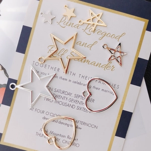 Detailed view of DIY metal star and heart pendants in gold and silver for jewelry making