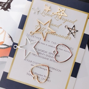 Macro shot of gold and silver star and heart charms for DIY jewelry making