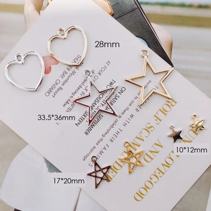 Close-up of gold and silver hollow heart and star pendants for DIY jewelry making