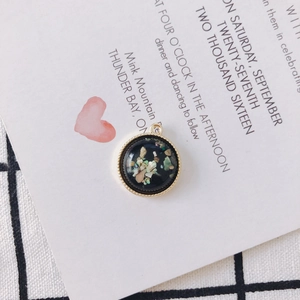 Macro detail of a round shell inlay pendant for DIY jewelry making on card background