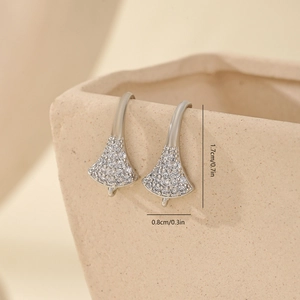 Detailed close-up of silver fan-shaped earring hooks with cubic zirconia micro-pave setting