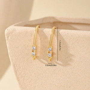 Macro detail of gold earring hooks with cubic zirconia showing 1.7cm dimensions