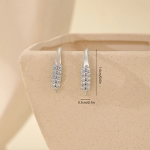 Macro shot of silver earring hooks with double-row zircon inlay and 1.6cm dimensions