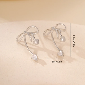 Detail view of gold-plated bow heart earrings with dimensions 2.2cm by 2cm