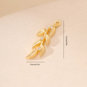 Detailed view of leaf pendant with gold plating and four round cubic zirconia stones