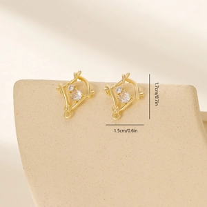 Detail view of gold leaf earrings with zircon measuring 1.7cm height and 1.5cm width