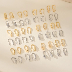 Detailed macro view of various gold and silver DIY earring hooks and jewelry components