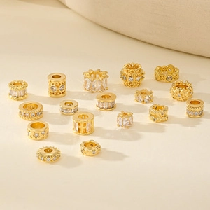 Detailed view of gold-plated oval charms with cubic zirconia for DIY jewelry making