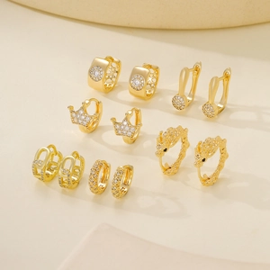 Luxury gold earrings set with six pairs of zircon studs and crown hoop earrings