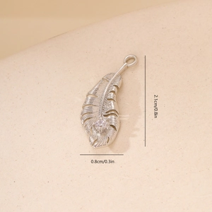 Detailed close-up of silver feather pendant with zircon inlay and exact dimensions