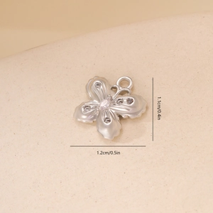 Detailed macro shot of silver butterfly pendant with white cubic zirconia stones 1.2cm