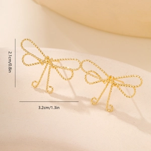 Macro detail of gold bow earrings featuring an intricate twisted rope texture and size specs