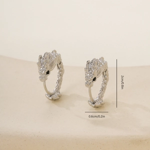 Macro shot of silver dragon head earrings detailing the scales and measurement 2cm