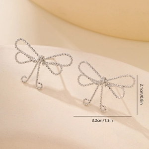 Detailed size view of silver bow-shaped stud earrings featuring a textured woven design