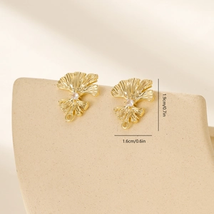 Detailed view of gold leaf stud earrings with white zircon and size markers