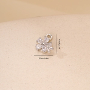 Macro shot of a 0.9cm zircon flower pendant with a bow detail for jewelry making