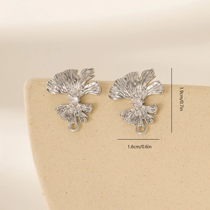 Macro detail of leaf-shaped earring studs with cubic zirconia and dimensions