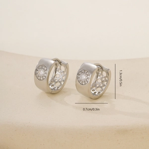 Detail view of silver hoop earrings with zircon stones and honeycomb hollow side design