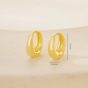 Detailed view of glossy gold teardrop hoop earrings measuring 1.4cm on ceramic plate