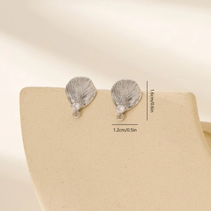 Macro view of leaf-shaped silver earring components with zircon inlay for DIY jewelry