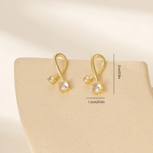 Detail showing the 2cm by 1.2cm size measurements of gold leaf earrings with zircons