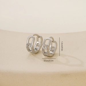 Macro detail of silver geometric chain earrings with zirconia inlay showing 1.2cm size
