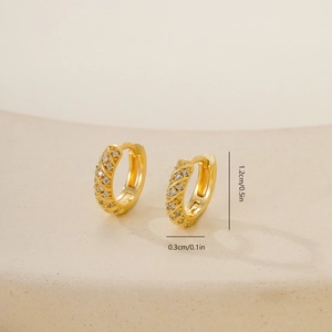 Detail of 1.2cm gold huggie hoop earrings with twisted design and cubic zirconia pavé