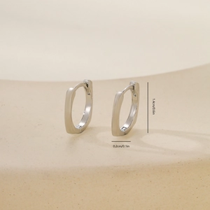 Macro detail of geometric silver metal hoop earrings with precise size measurement labels