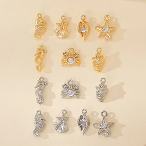 Detailed view of nautical jewelry charms including seahorse and starfish with zircons