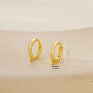 Detailed view of golden 1.3cm round hoop earrings with small loops for DIY jewelry making