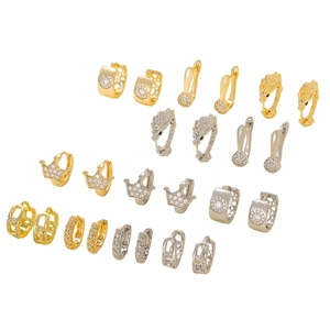 Assorted gold and silver hoop earrings with cubic zirconia patterns on white backdrop