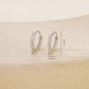 Macro view of 1.4cm polished silver metal earring hoops with DIY hanging loops