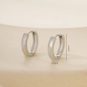 Polished silver huggie hoop earrings with detailed dimensions of 1.4cm height and 0.3cm width