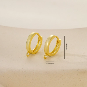 Macro detail of golden metal earring hoops with dimensions 1.5cm by 0.3cm for DIY crafts