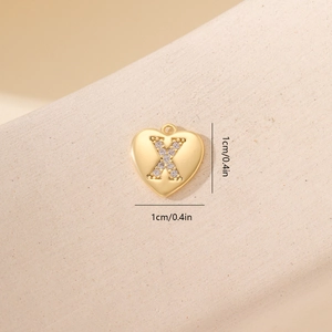 Dettaglio di un ciondolo a cuore da 1cm placcato oro con lettera X in zirconi