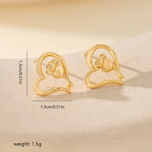 Macro shot of gold-plated hollow heart earrings with rose detail and 1.3cm size marking