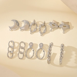 Collection of geometric silver metal earring components with stars and moon shapes