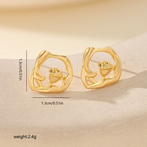 Detail shot of gold flower stud earrings with dimensions 1.3cm and 2.4g weight