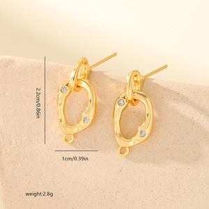 Macro view of gold-plated oval link earrings with inset crystals and size details