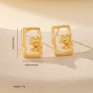 Macro view of gold-plated floral earrings showing dimensions 1.4cm by 0.9cm