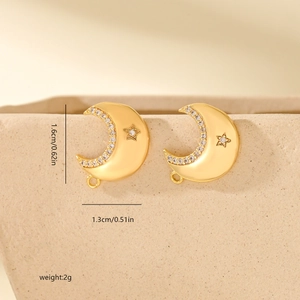Detailed view of gold plated crescent moon and star earrings with white zircon stones