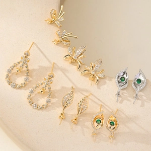 Close-up of geometric jewelry pendants with gold and silver finishes and zircon stones