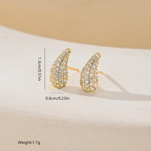 Macro shot of geometric teardrop stud earrings with gold plating and cubic zirconia